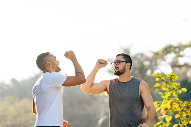 Athletes greeting with elbow in natural park