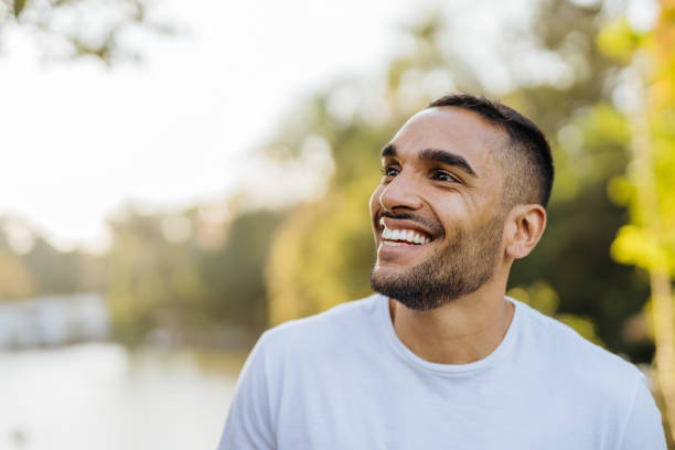 istock Young smiling athlete in public park 1368477530