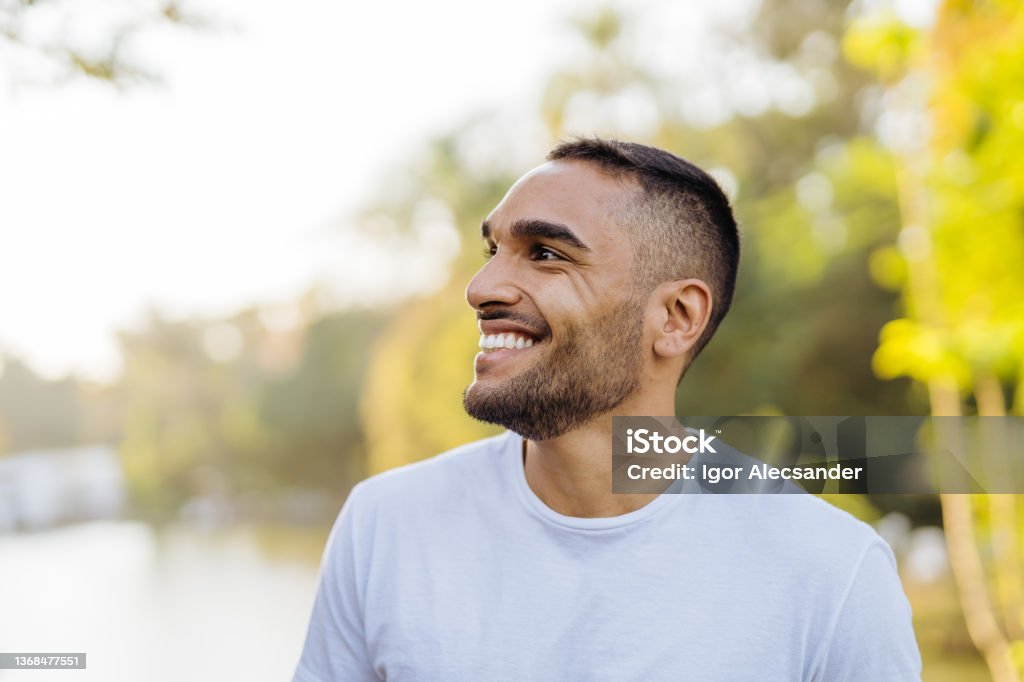 Young smiling athlete in public park Happiness Stock Photo