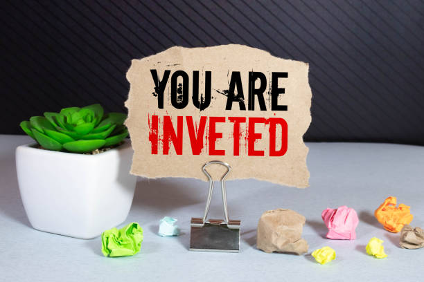 istock YOU ARE INVETED. text on white notepad paper. near torn blue paper 1368477638
