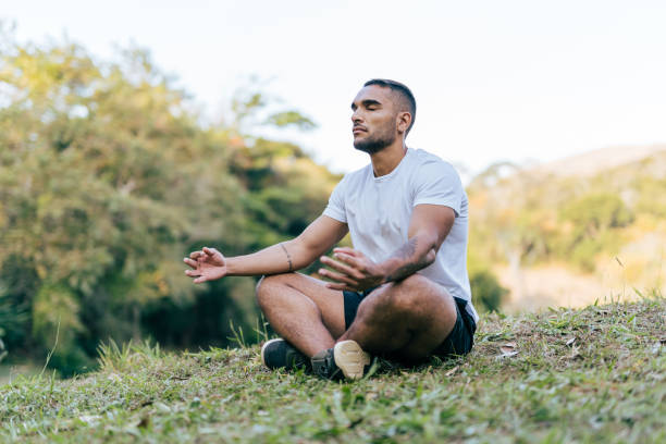 istock Athlete meditating in the public park 1368477681