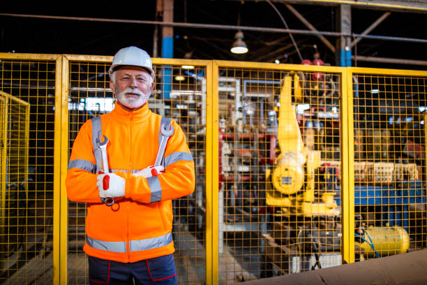 istock Portrait of factory expert serviceman holding tools for maintaining automated processing machines. 1368478832