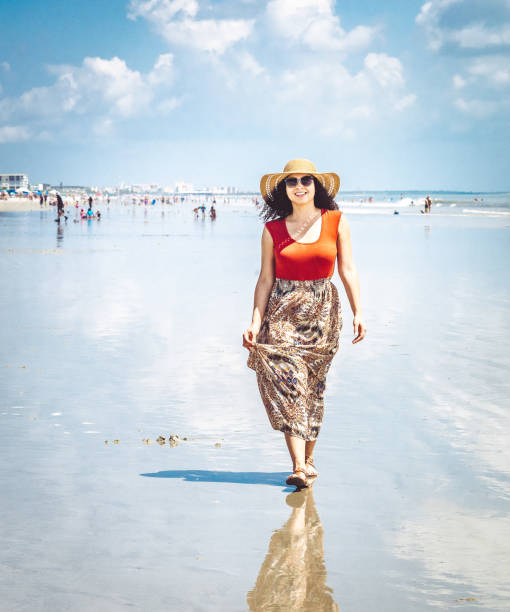 Confident stylish Afro-Caribbean woman enjoying a beach vacation Beautiful carefree Afro-Caribbean woman on a beach in Florida cocoa beach stock pictures, royalty-free photos & images