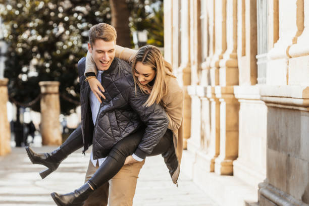 istock Couple having fun while he carries her on his back 1368484152
