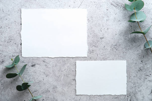 istock Wedding RSVP cards templates with eucalyptus on stone table top view. 1368485032
