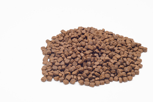 Healthy dog food of lamb with vitamins with no additive artificial flavor and color over white background.