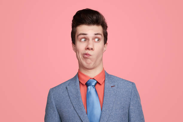 istock Funny uncertain businessman hesitating in studio 1368491549