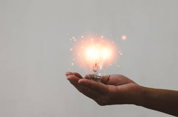 istock hand holding light bulb ideas Great inspiration and innovation 1368491620