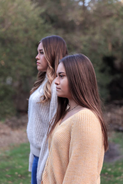 Sisters looking off in the distance in nature
