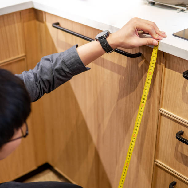 istock Asian man using tape measure on kitchen counter 1368495269