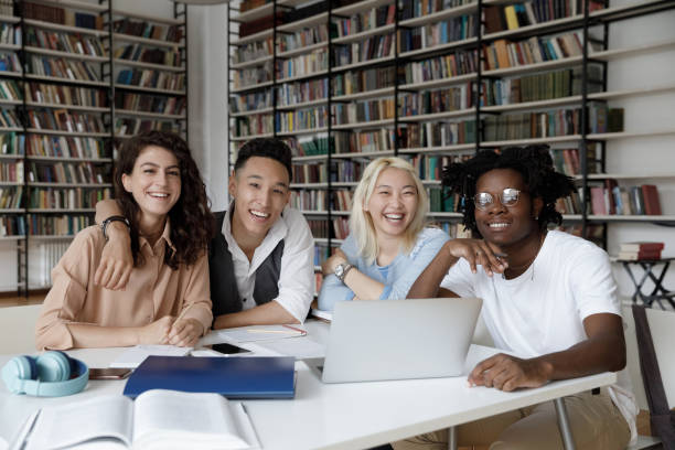 istock Happy positive diverse teen students studying together in university library 1368496785