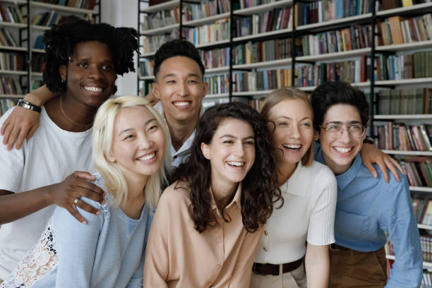 istock Diverse group of student girls and guys posing in library 1368496797