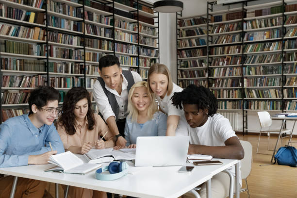 istock Multiracial group of students watching online learning presentation together 1368496799