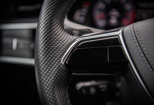 Modern Car Steering Wheel Close Up. Automotive Industry Theme.