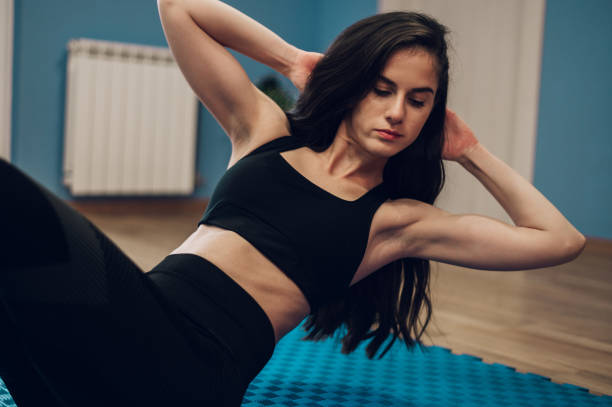 istock Woman training at home and doing pushups 1368498144