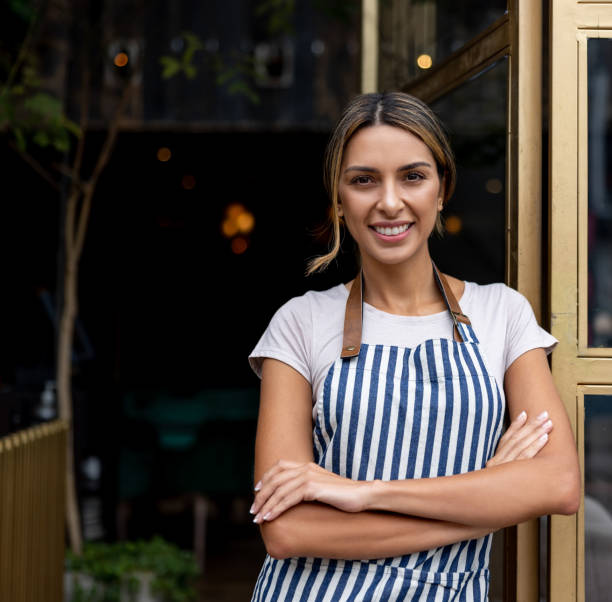 istock Happy waitress working at a restaurant and smiling 1368500011