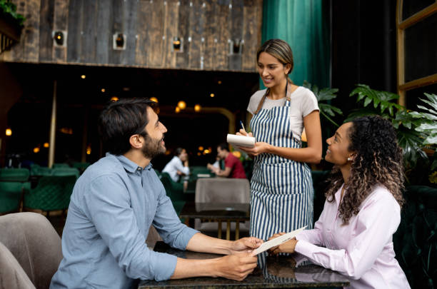 istock Waitress taking the order of a couple at a restaurant 1368500018