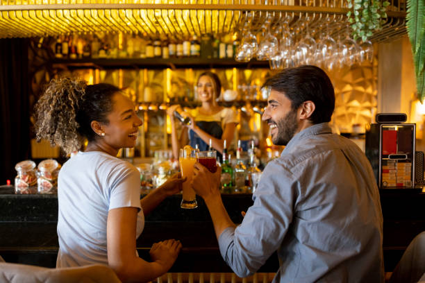 istock Happy couple having drinks at a bar 1368500103
