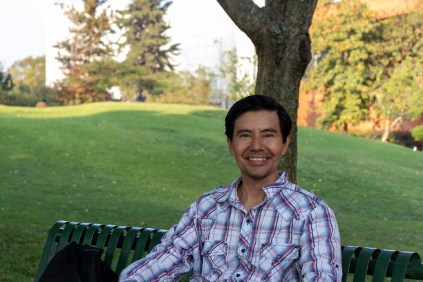 istock Happy hispanic man smiling and looking at camera on a park in guatemala 1368500190