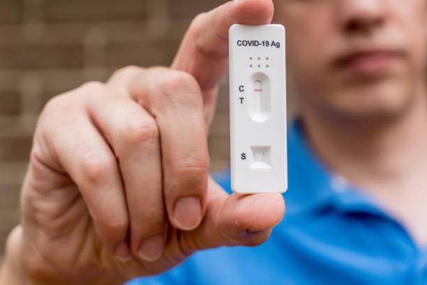 istock Man holding Covid-19 rapid antigen test cassette with negative result of rapid diagnostic test. Self-testing kit 1368501521