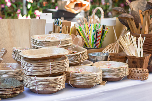 Dishes made from dry pressed palm leaves on market in Thailand. Concept of reuse of waste. Eco-friendly and zero waste theme.