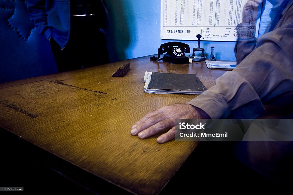 Prison director A prison director, a desk and somebody listening. The director is potentialy a ghost. (Long exposure) Police Force Stock Photo