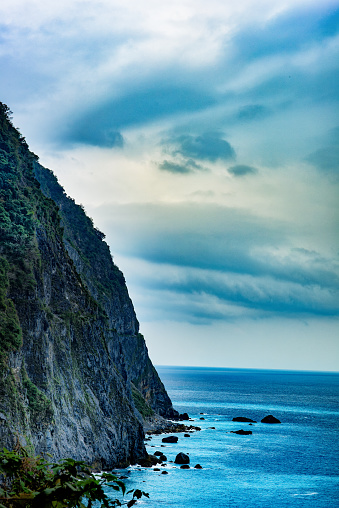 A beautiful landscape with colorful waters at the cliffs of the Taiwanese Pacific Coast, near Hualien and Taroko Gorge National Park.