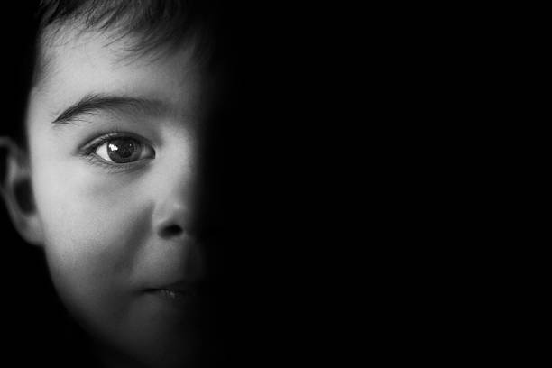 Darkness Little boy getting out of the darkness. child abuse photos stock pictures, royalty-free photos & images