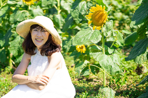 Woman smiling in the sunflower field in Biei, Hokkaido, Japan