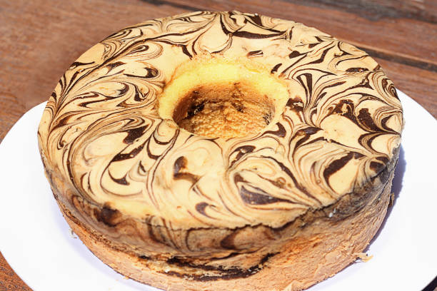 istock Homemade round sponge cake mix on white table. 1368514531
