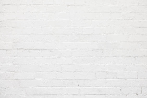 istock Part of an old brick wall painted white 1368514811