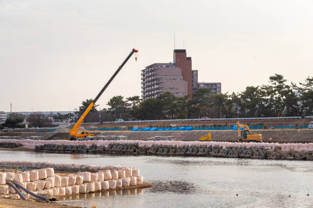 istock Crane and excavator working on riverbank 1368516513