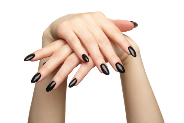 istock Female hands with black nails manicure isolated on white background. 1368516682