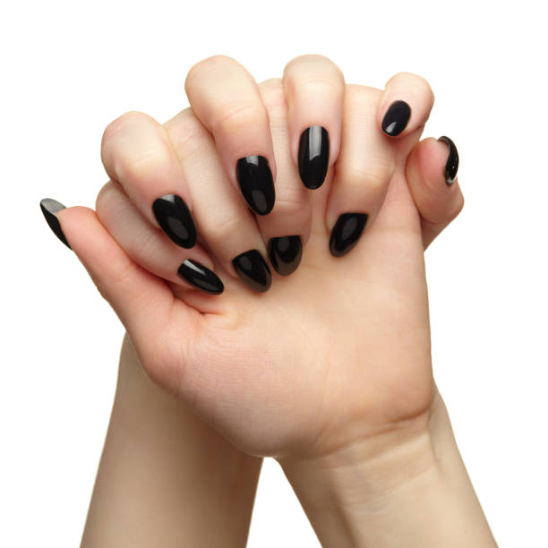 istock Female hands with black nails manicure isolated on white background. 1368516687
