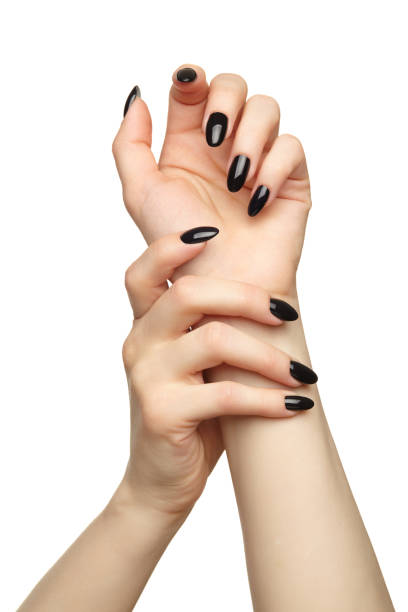 istock Female hands with black nails manicure isolated on white background. 1368516711