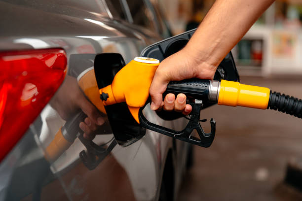 istock Hand refilling the car with fuel. 1368523781