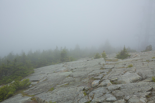 Low clouds enshroud the summit of Mt. Kearsarge in fog at WInslow State Park in Wilmot, New Hampshire.