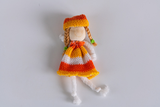 Knitted doll with hat and scarf, standing pose