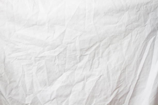 istock Wrinkled sheet. White fabric close-up. Burlap texture. Sheet on the bed. 1368527803