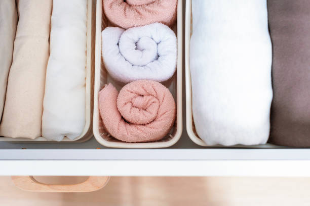 istock Clothes and towels in plastic box in closet top view, space organization concept. 1368527934