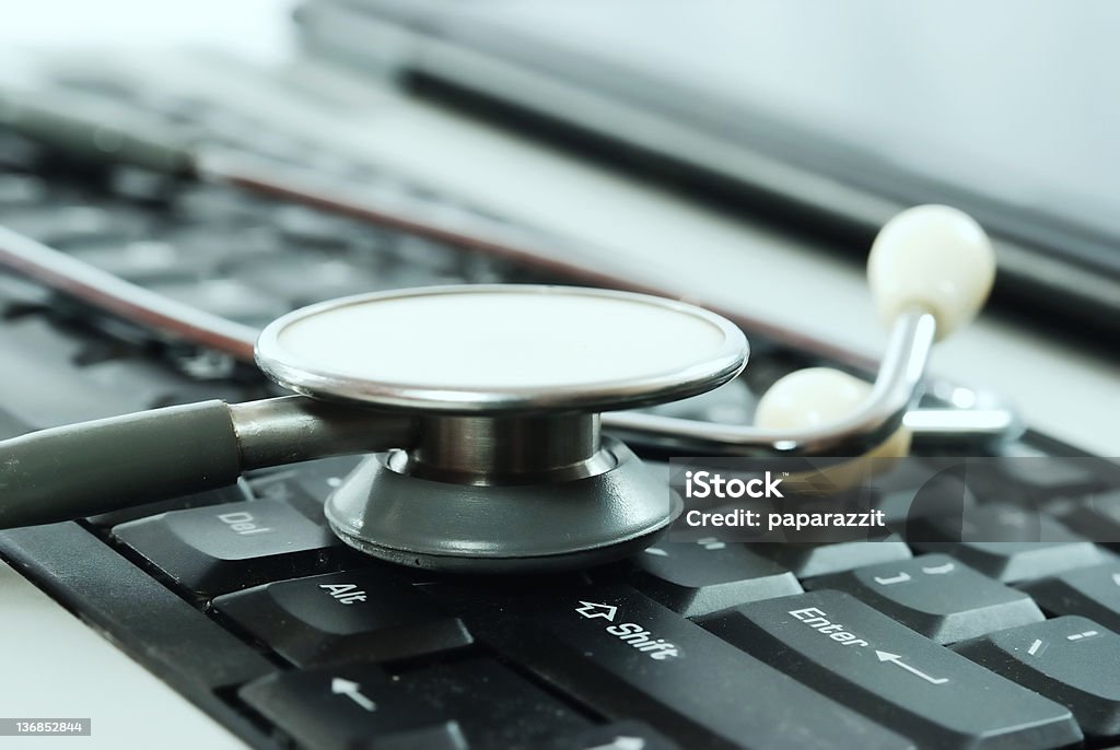 computer doctor laptop keyboard and a stethoscope, shot on white Business Stock Photo
