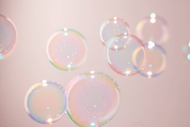 istock Beautiful Colorful Transparent Soap Bubbles Floating on Pink Background 1368528877