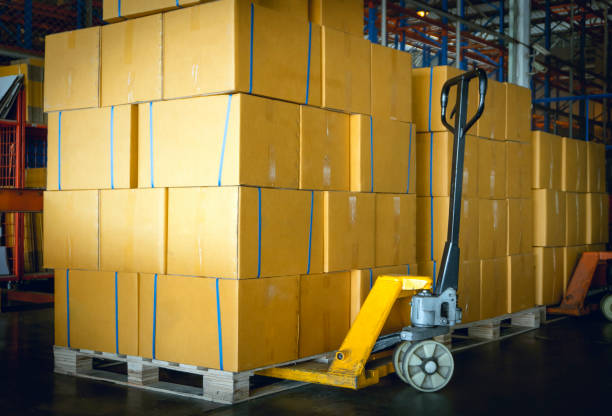 istock Packaging Boxes on Pallets Racks with Hand Pallet Truck in Storage Warehouse. Supply Chain. Storehouse Shipment Goods. Distribution Warehouse Shipping Logistics. 1368528880