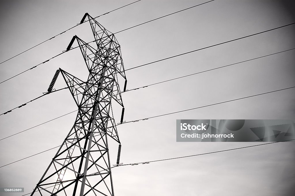 High Voltage Powerlines High voltage power lines against a stormy sky. Anxiety Stock Photo