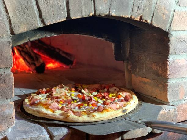 istock Pizza and brick pizza oven with fire. 1368528950