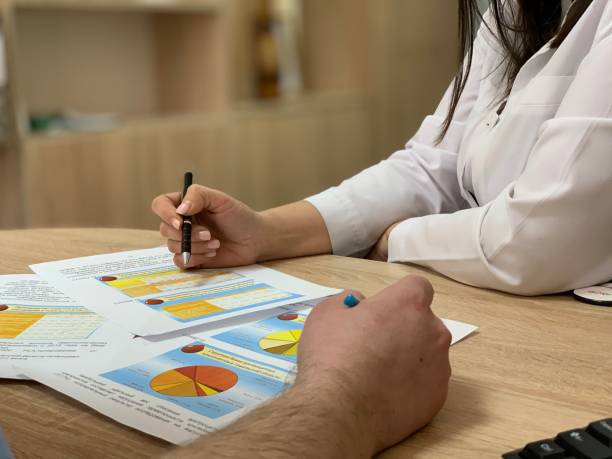 istock Mature doctors discussing medical records. 1368530648