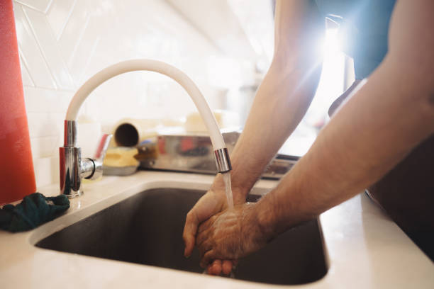 istock Chef washing his hands in a restaurant kitchen sink 1368530847