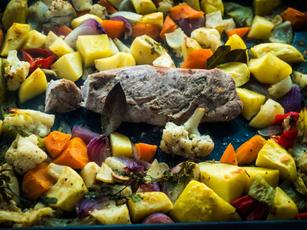 preparing pork leg with vegetables and red wine in the pan. - bay leaf healthy eating food and drink red imagens e fotografias de stock