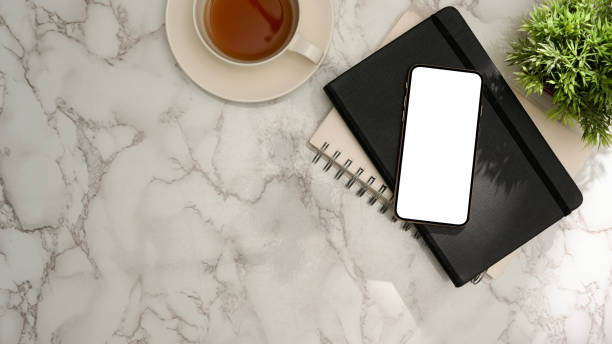 istock Workspace with smartphone mockup and copy space on marble background. 1368533385