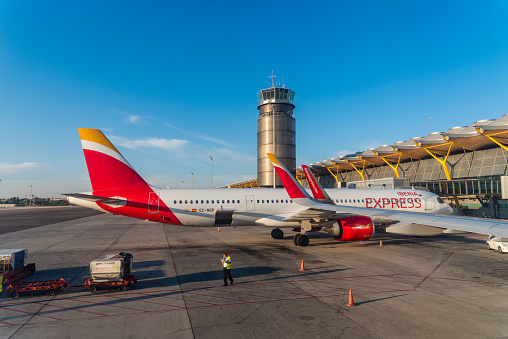 Madrid, Spain - August 2, 2021: Airplanes in the runways of Barajas Airport. T4 Terminal. Madrid-Barajas Adolfo Suarez. Iberia Express
